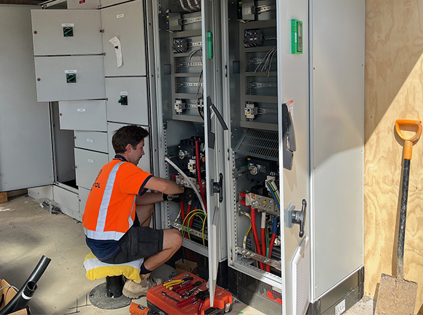 Person installing electrical hardware