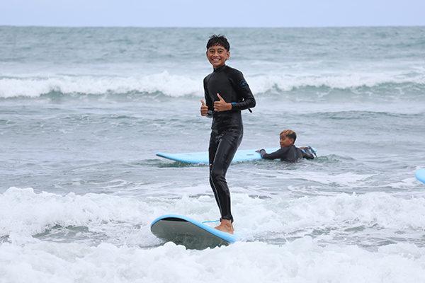 Student Nikau surfing in Raglan
