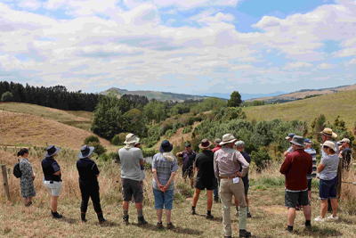 Group shot of the Karapiro Catchment group receiving a tour of the plantings on Ian's farm